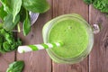 Green smoothie with kale and spinach. Top view table scene on a wood background. Royalty Free Stock Photo