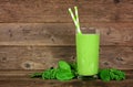 Green smoothie with kale and spinach in a glass on a dark wood background Royalty Free Stock Photo