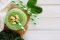 Green smoothie in a mason jar, top view, corner border on white wood Royalty Free Stock Photo