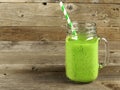 Green smoothie on old wood background