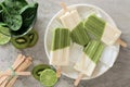 Green smoothie popsicles on a marble plate, above view