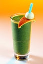 Green smoothie with a slice of orange.