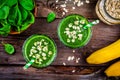 Green smoothie with spinach, banana and oatmeal on a wooden background. top view Royalty Free Stock Photo