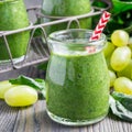 Green smoothie with spinach, grape and banana, garnished with raspberries, square format Royalty Free Stock Photo