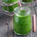 Green smoothie with spinach, grape and banana, garnished with raspberries, square format Royalty Free Stock Photo