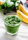 Green smoothie with spinach, kiwi, mint and banana, selective focus
