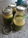 Green Smoothie with staw in glass jar