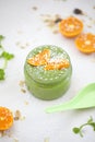 Green smothie with mandarine and granola.