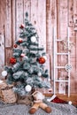 Green snowy Christmas Tree on Wooden Background with Copy space decorated with cristmas toys Royalty Free Stock Photo
