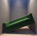 Green sofa stuck in between the walls in the small room apartment Royalty Free Stock Photo