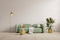 Green sofa with table on white wall and wooden flooring Royalty Free Stock Photo