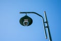 Green solar-powered street lamp. Solar-powered street lamp against the blue sky. Royalty Free Stock Photo