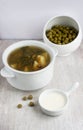 Green soup in the china plate and preserved peas Royalty Free Stock Photo