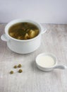 Green soup in the china plate and sour cream Royalty Free Stock Photo