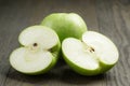 Green sour apple on wood table sliced Royalty Free Stock Photo