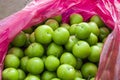 Green sour plums bought from the market, plum in bag, delicious plums