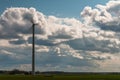 Wind power station - wind turbine against the cloudy sky. Spring Central Sweden Royalty Free Stock Photo