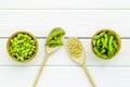 Green soybeans or edamame in spoon and bowl for fresh healthy food on white wooden background top view Royalty Free Stock Photo