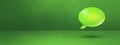 Green speech bubble on concrete wall banner background Royalty Free Stock Photo