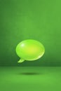 Green speech bubble on concrete wall vertical background Royalty Free Stock Photo