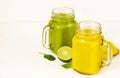 Green Spinach Avocado Smoothie and Banana Mango Smoothie in jars