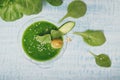 Green spinach and cucumber smoothie on light blue wooden background. Royalty Free Stock Photo