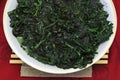 Green spinach dish on the red