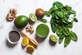 Green spinach and mango smoothie with ingredients on white marble background. Detox drinks concept Royalty Free Stock Photo