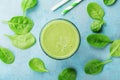 Green spinach smoothie on blue table top view. Detox and diet food for breakfast. Royalty Free Stock Photo