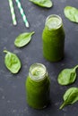 Green spinach smoothie in glass jar on dark black table, detox food for breakfast Royalty Free Stock Photo