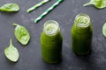 Green spinach smoothie in glass jar on dark black table, detox food for breakfast Royalty Free Stock Photo