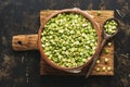 Green split peas in a bowl on a cutting board. Top view. Royalty Free Stock Photo