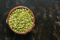 Green split peas in a bowl on a dark background. View from above. Royalty Free Stock Photo