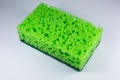 Green sponge for washing dishes on white background. Artificial fiber not eco-friendly tool. Things for kitchen Royalty Free Stock Photo