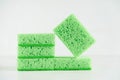 Green sponges for cleaning on a white background