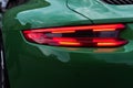 Green sports car. Car backlight on. Closeup. Royalty Free Stock Photo