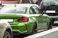 Green sports car on the street of the city details stop lights