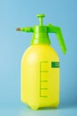 Yellow Spray Dispenser Pump Plastic Bottle on blue background. Plastic spray gun. High resolution photo. Royalty Free Stock Photo