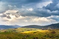 Green spring alpine scene. Spring rain and storm.