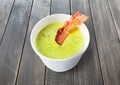 Green spring pea soup with bacon at gray wood Royalty Free Stock Photo