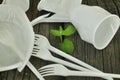 A green sprout among wooden planks, among plastic garbage. The concept of ecology, protection of nature Royalty Free Stock Photo