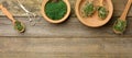 Green sprouts of chia, arugula and mustard in a wooden spoon on a background from old gray boards, top view Royalty Free Stock Photo