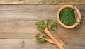 Green sprouts of chia, arugula and mustard in a wooden spoon on a gray background from old gray boards, top view. Useful Royalty Free Stock Photo