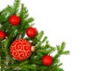 Green spruce branches border with red christmas balls on white background, corner design Royalty Free Stock Photo