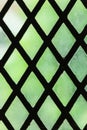 Green stained glass window with regular block pattern Royalty Free Stock Photo