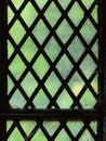 Green stained glass window with regular block pattern Royalty Free Stock Photo