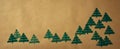 Green stamped christmas trees over paper