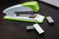 Green stapler on a black background Royalty Free Stock Photo