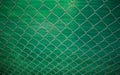 Green steel wire chain link net fence. Galvanized pvc coated chain link fence. Fence made of steel wire mesh. Rusty wire