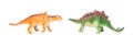 Green stegosaurus and orange pinacosaurus toy on white background Royalty Free Stock Photo